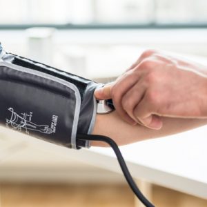 A primary care physician administers a blood pressure test.