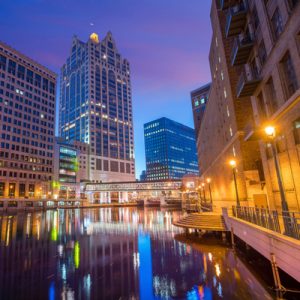 A Midwestern city at night with buildings lit up.