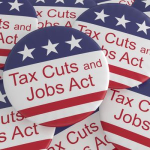 Buttons decorated like the American flag, with "Tax Cuts and Jobs Act" written on them.